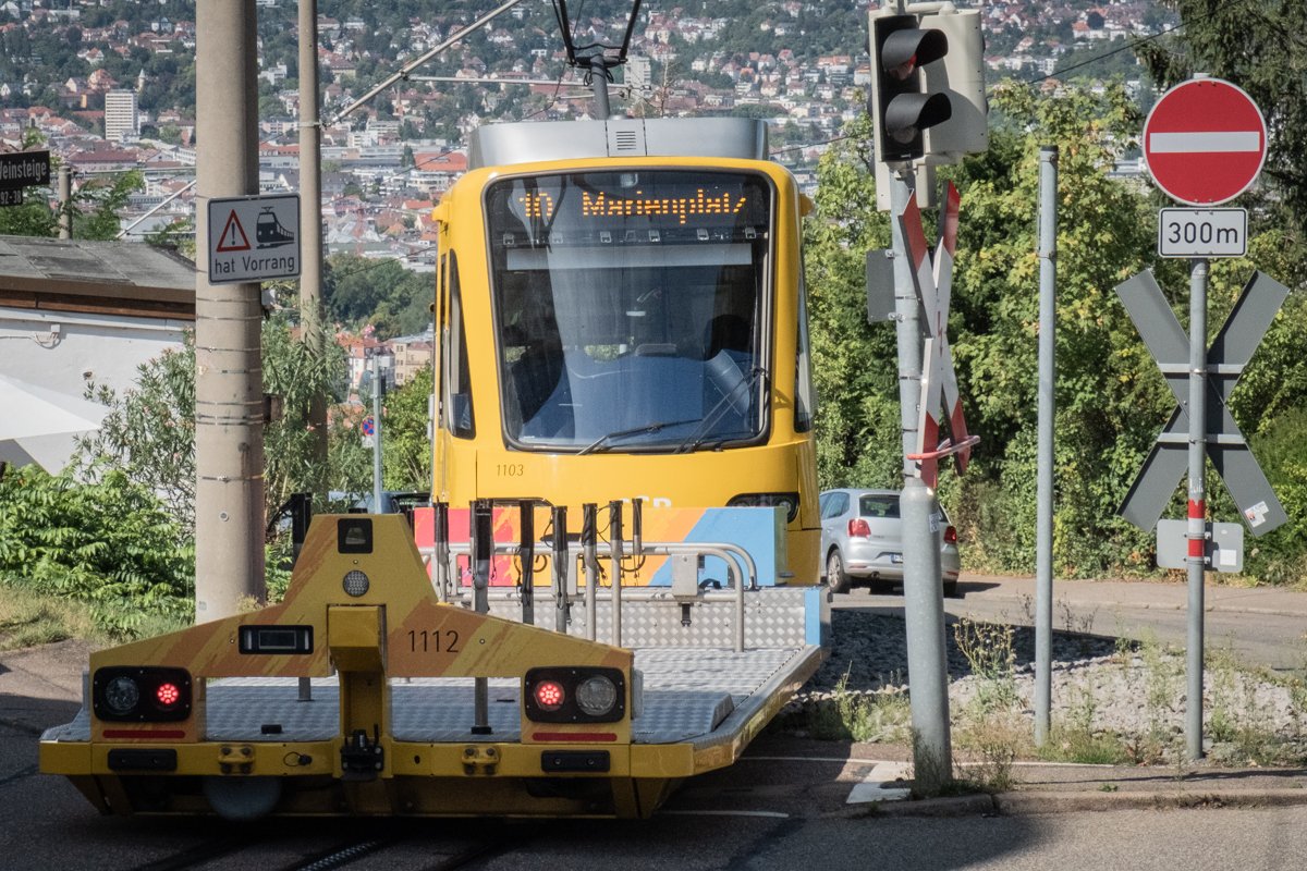 Stuttgart's yellow Zahnradbahn, a rack railway, climbs the hillside toward Degerloch. The city disappears behind it.
