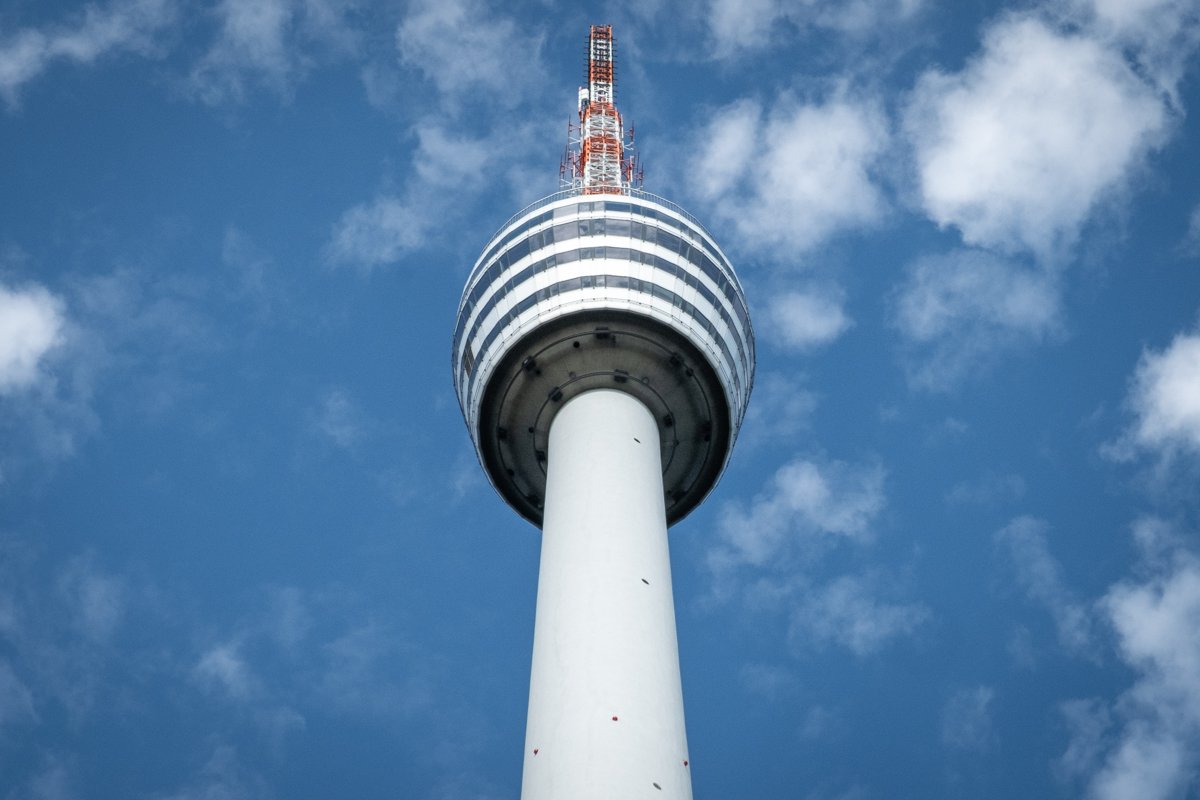 The Stuttgart Fernsehturm (TV Tower) rises toward the blue sky.