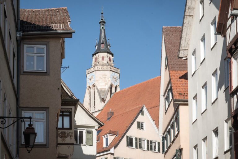 View of the Stiftskirche tower rising above the rooftops in Tübingen's Altstadt.